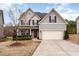 Charming two-story home with vinyl siding, mature landscaping, and a two-car garage at 410 Pintail Ct, Durham, NC 27704