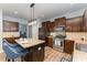 Modern kitchen showcasing stainless appliances, dark wood cabinetry, and an island with barstools at 410 Pintail Ct, Durham, NC 27704