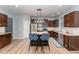 Stylish kitchen featuring dark cabinets, stainless steel appliances, and an island with seating at 410 Pintail Ct, Durham, NC 27704