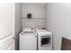 Practical laundry room with modern washer and dryer, plus overhead storage shelf at 410 Pintail Ct, Durham, NC 27704