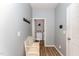 Organized mudroom with a bench, coat hooks, and entry to the laundry room at 410 Pintail Ct, Durham, NC 27704