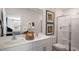 A modern bathroom with double sinks, a glass-enclosed shower, and neutral decor at 416 Belgian Red Way, Wake Forest, NC 27587
