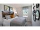 Well-lit bedroom boasts decor, a large window overlooking the neighborhood, and stylish wall accents at 416 Belgian Red Way, Wake Forest, NC 27587
