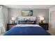 Comfortable bedroom features a stylish bed with blue bedding, side tables with lamps, and artwork on the wall at 416 Belgian Red Way, Wake Forest, NC 27587