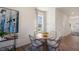Cozy dining area featuring a round table with four chairs, a window, and modern art at 416 Belgian Red Way, Wake Forest, NC 27587