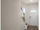 Bright entryway featuring hardwood floors, a staircase with dark railings, and a white front door at 416 Belgian Red Way, Wake Forest, NC 27587