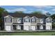 Charming townhome exterior with gray siding, white trim, dark shutters and a one-car garage at 416 Belgian Red Way, Wake Forest, NC 27587