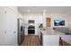 Modern kitchen features stainless steel appliances, granite countertops, and sleek white cabinetry at 416 Belgian Red Way, Wake Forest, NC 27587