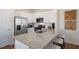Stylish kitchen featuring white cabinets, stainless appliances, and a granite countertop island with seating at 416 Belgian Red Way, Wake Forest, NC 27587