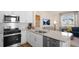 Modern kitchen boasts stainless steel appliances, granite countertops, and white cabinetry at 416 Belgian Red Way, Wake Forest, NC 27587