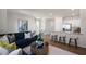 Open concept living room and kitchen features a large sofa, modern furniture, and an eat in kitchen at 416 Belgian Red Way, Wake Forest, NC 27587