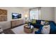 Cozy living room with comfortable blue sofa, stylish decor, and large windows for natural light at 416 Belgian Red Way, Wake Forest, NC 27587