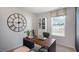 Bright office space featuring a rustic desk, large clock, a white bookshelf, and a window with neighborhood views at 416 Belgian Red Way, Wake Forest, NC 27587