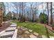 Grassy backyard with walking stones to access all areas at 4228 Bibleway Ct, Holly Springs, NC 27540