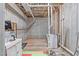 Unfinished basement offers great potential for storage, with laundry machines and room for customization at 4228 Bibleway Ct, Holly Springs, NC 27540