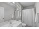 Well-lit bathroom with white vanity, a decorative mirror, and a shower-tub combination with neutral color at 4228 Bibleway Ct, Holly Springs, NC 27540