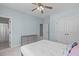 Comfortable bedroom featuring a ceiling fan, multiple closets, and a gray dresser for extra storage space at 4228 Bibleway Ct, Holly Springs, NC 27540