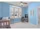 Bright bedroom with large window, features carpeted floors, ceiling fan, and views of the neighborhood at 4228 Bibleway Ct, Holly Springs, NC 27540