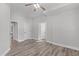 Spacious bedroom features neutral walls, wood-look floors, and three doors to closets or other rooms at 4228 Bibleway Ct, Holly Springs, NC 27540