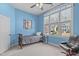 Charming blue bedroom with a large window, featuring a comfortable bed and modern decor at 4228 Bibleway Ct, Holly Springs, NC 27540