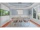 Elegant dining room featuring a tray ceiling, modern light fixture, and custom built-in aquarium at 4228 Bibleway Ct, Holly Springs, NC 27540