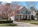 Beautiful two-story home with flowering tree in yard and curved driveway at 4228 Bibleway Ct, Holly Springs, NC 27540