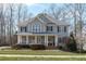 Charming two-story home featuring a welcoming front porch and classic architectural details at 4228 Bibleway Ct, Holly Springs, NC 27540
