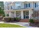 Inviting covered front porch with classic columns and brick steps at 4228 Bibleway Ct, Holly Springs, NC 27540