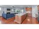 Open-concept kitchen island seamlessly connects to the living room with a built-in aquarium at 4228 Bibleway Ct, Holly Springs, NC 27540