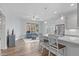 Open-concept kitchen showcases stainless steel appliances, island seating, and seamless flow into the living area at 4228 Bibleway Ct, Holly Springs, NC 27540