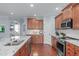 Spacious kitchen with granite countertops, stainless appliances, and wooden cabinets at 4228 Bibleway Ct, Holly Springs, NC 27540