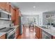 Well-lit kitchen flowing into the breakfast nook, featuring granite counters and stainless appliances at 4228 Bibleway Ct, Holly Springs, NC 27540