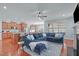 Open-concept kitchen and living area featuring hardwood floors, a fireplace, and comfortable blue sectional at 4228 Bibleway Ct, Holly Springs, NC 27540