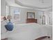Bright main bedroom with windows, a ceiling fan, and complemented by a wooden dresser and mirror at 4228 Bibleway Ct, Holly Springs, NC 27540