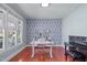 Bright office space featuring a large window, modern desk, and stylish wallpaper at 4228 Bibleway Ct, Holly Springs, NC 27540