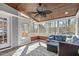 Relaxing screened-in porch featuring a ceiling fan, comfortable seating, and views of the backyard trees at 4228 Bibleway Ct, Holly Springs, NC 27540