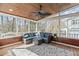 Screened porch features comfortable seating, a wood ceiling and a ceiling fan with views of a wooded backyard at 4228 Bibleway Ct, Holly Springs, NC 27540