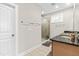 Clean bathroom with a glass-enclosed shower, neutral tile, and a single sink vanity at 424 Hopwood Way Way, Apex, NC 27523