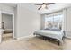 Comfortable bedroom with a cozy bed and a view of the neighborhood, plus neutral walls and carpeted floors at 424 Hopwood Way Way, Apex, NC 27523