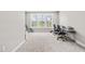 Bright bedroom space featuring large windows offering scenic outdoor views, plus carpeted floors and neutral walls at 424 Hopwood Way Way, Apex, NC 27523