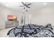 Comfortable bedroom with neutral colors, ceiling fan, and a modern dresser and TV at 424 Hopwood Way Way, Apex, NC 27523