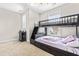 Cozy bedroom featuring a dark bunk bed, neutral walls, carpeted floors, and natural light from a window at 424 Hopwood Way Way, Apex, NC 27523