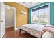 Inviting bedroom with large windows and colorful walls and neutral trim at 424 Hopwood Way Way, Apex, NC 27523