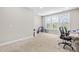 Bright bedroom featuring large windows offering scenic outdoor views, plus carpeted floors and neutral walls at 424 Hopwood Way Way, Apex, NC 27523