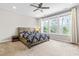Bright bedroom features a large window, ceiling fan, and carpeted flooring at 424 Hopwood Way Way, Apex, NC 27523