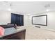 Bonus room featuring a large projector screen, comfortable seating, and neutral walls, ideal for a home theater at 424 Hopwood Way Way, Apex, NC 27523