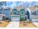 Charming two-story home with vibrant turquoise siding, white trim, and a well-maintained front yard at 424 Hopwood Way Way, Apex, NC 27523
