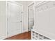 Bright hallway with white trim, mudroom storage, and rich hardwood flooring at 424 Hopwood Way Way, Apex, NC 27523