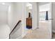 Hallway showcasing stairs with wood handrail, plus doorways to a bathroom and a bedroom at 424 Hopwood Way Way, Apex, NC 27523