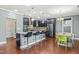 Stylish kitchen features dark cabinetry, granite countertops, a breakfast bar, and stainless steel appliances at 424 Hopwood Way Way, Apex, NC 27523